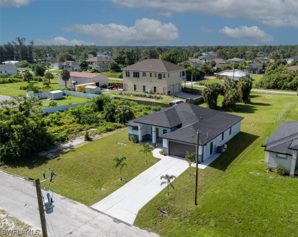 3915 20th Street Southwest Lehigh Acres, FL 33976 - Photo 46 of 50 an aerial view of a house with a garden and lake view