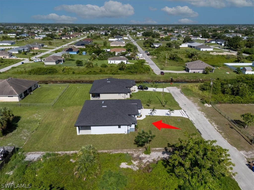 3915 20th Street Southwest Lehigh Acres, FL 33976 - Photo 47 of 50 an aerial view of residential houses with outdoor space and parking