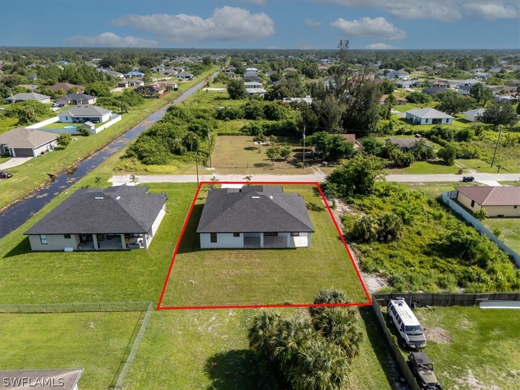 3915 20th Street Southwest Lehigh Acres, FL 33976 - Photo 48 of 50 an aerial view of residential houses with outdoor space and swimming pool