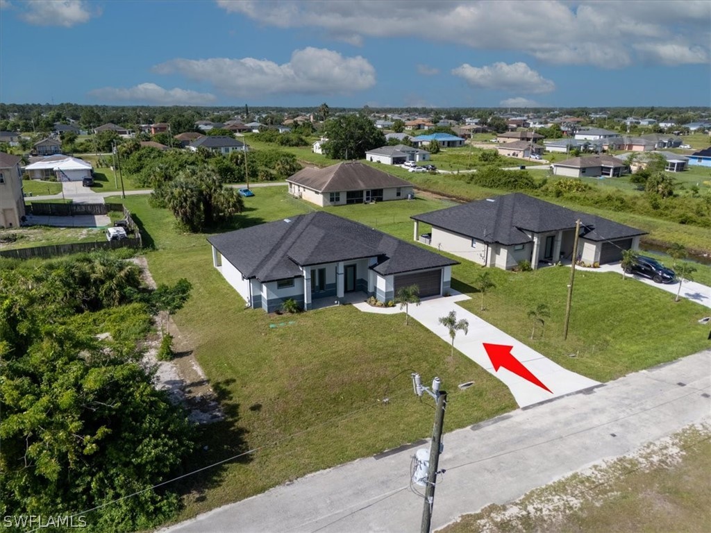 3915 20th Street Southwest Lehigh Acres, FL 33976 - Photo 50 of 50 an aerial view of residential houses with outdoor space and trees