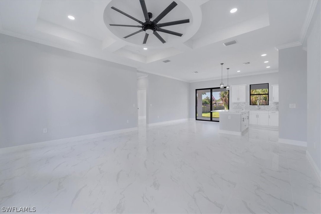 3915 20th Street Southwest Lehigh Acres, FL 33976 - Photo 5 of 50 an empty room with fan and windows