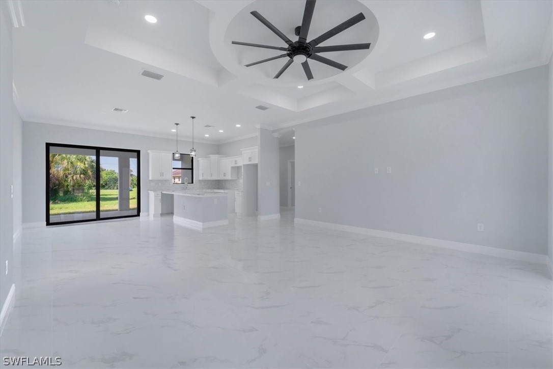 3915 20th Street Southwest Lehigh Acres, FL 33976 - Photo 6 of 50 an empty room with windows and ceiling fan