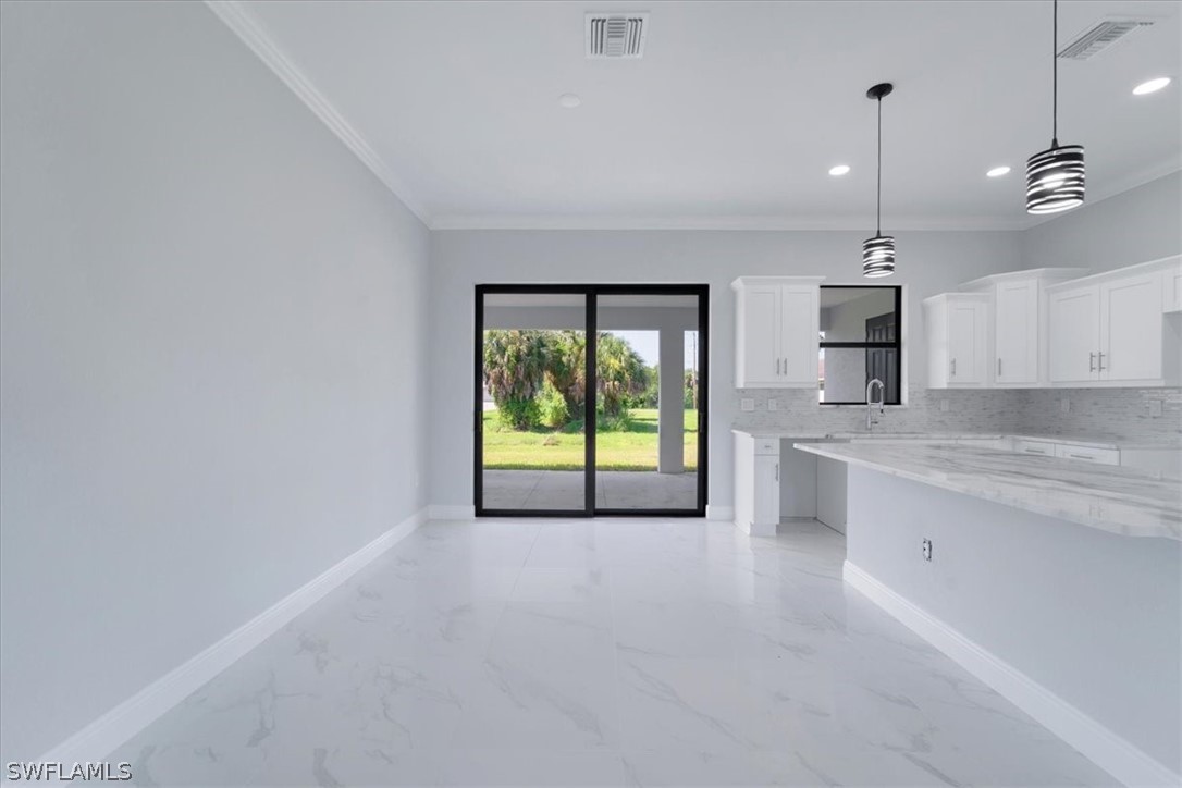 3915 20th Street Southwest Lehigh Acres, FL 33976 - Photo 7 of 50 a view of an empty room with a fireplace and a window