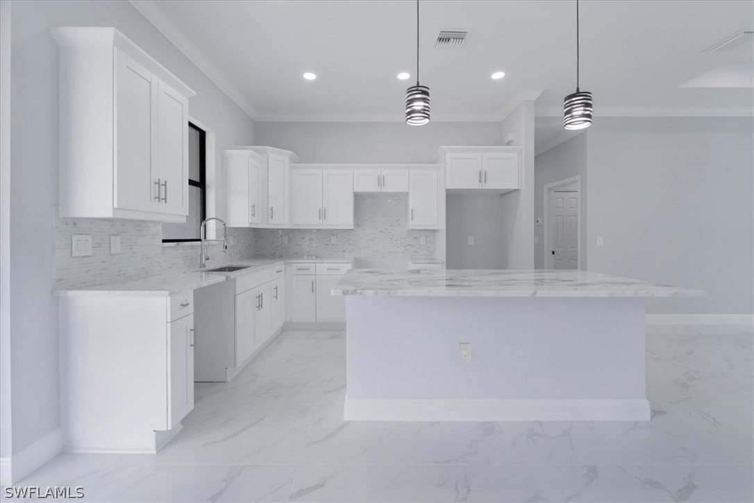 3915 20th Street Southwest Lehigh Acres, FL 33976 - Photo 9 of 50 a large kitchen with cabinets