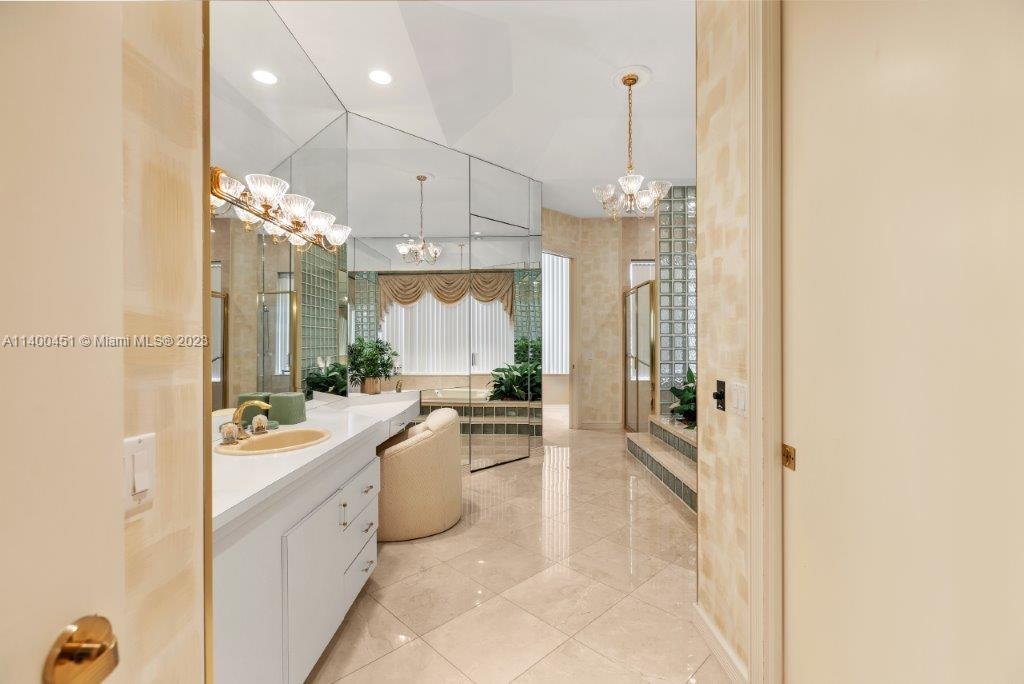 7236 Queenferry Circle Boca Raton, FL 33496 - Photo 11 of 31 a bathroom with a sink a faucet a mirror and a shower