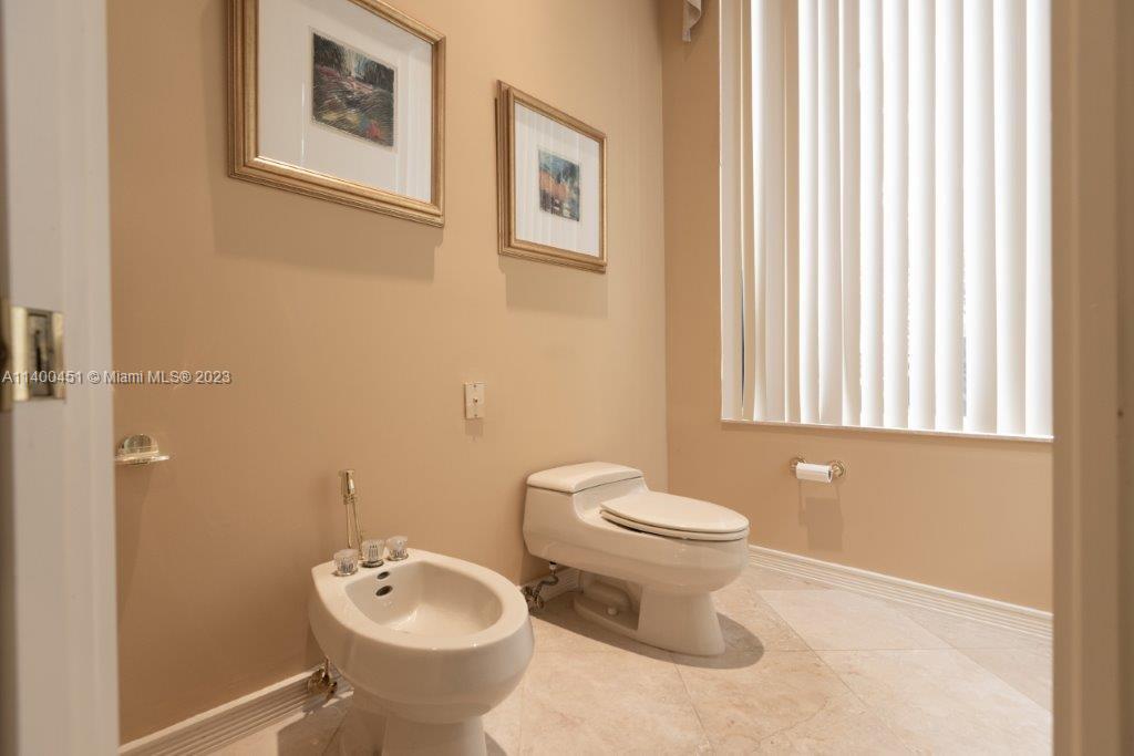 7236 Queenferry Circle Boca Raton, FL 33496 - Photo 13 of 31 a bathroom with a toilet sink and mirror