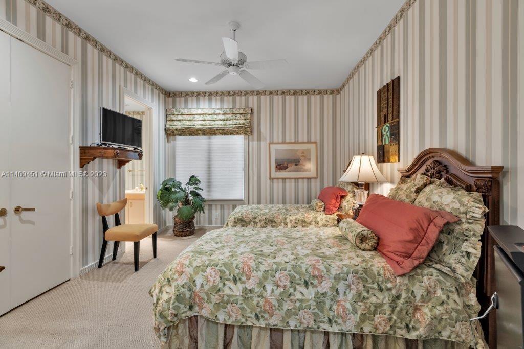 7236 Queenferry Circle Boca Raton, FL 33496 - Photo 14 of 31 a bedroom with a bed and a flat screen tv