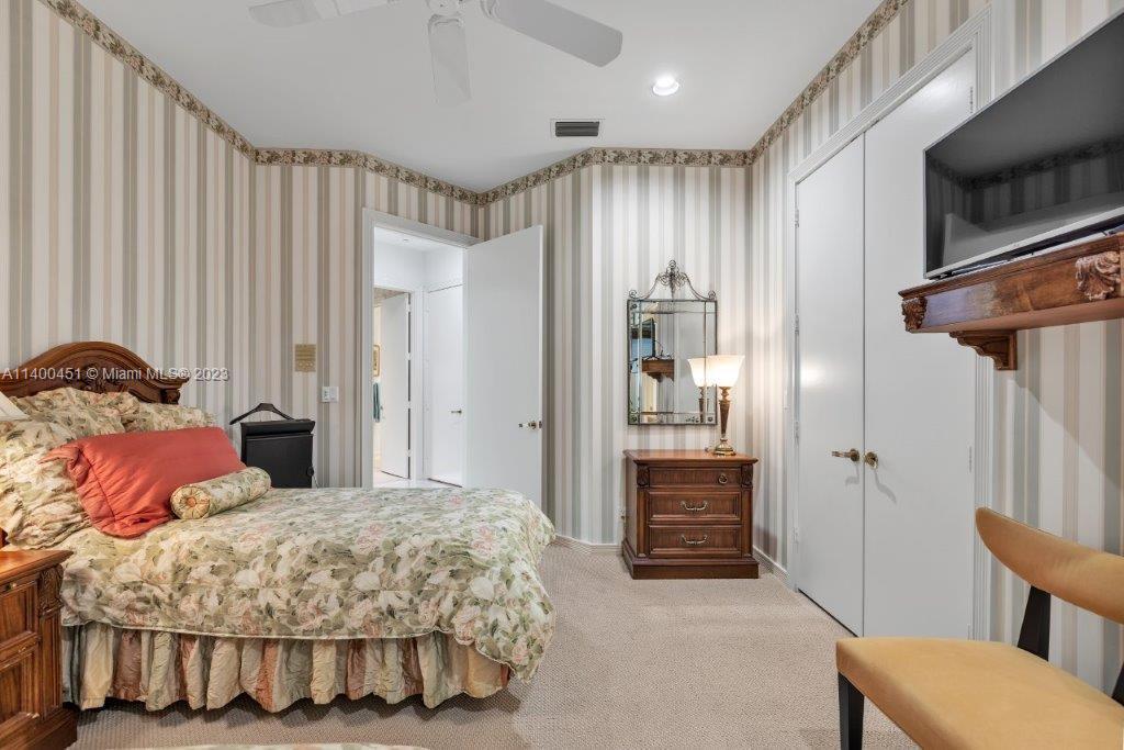 7236 Queenferry Circle Boca Raton, FL 33496 - Photo 15 of 31 a bedroom with a bed and a view of bathroom