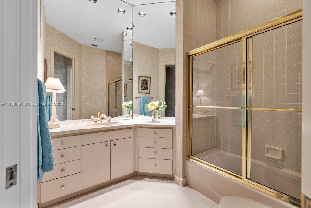 7236 Queenferry Circle Boca Raton, FL 33496 - Photo 18 of 31 a bathroom with a shower sink and mirror