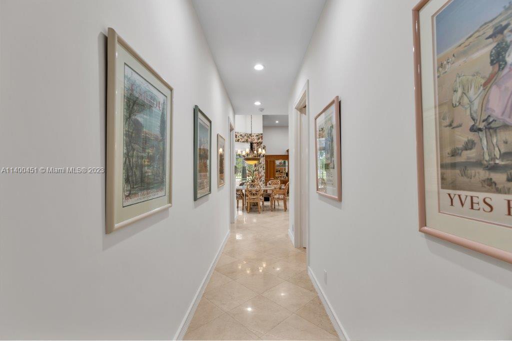 7236 Queenferry Circle Boca Raton, FL 33496 - Photo 19 of 31 a hallway with wooden floor and a bathroom