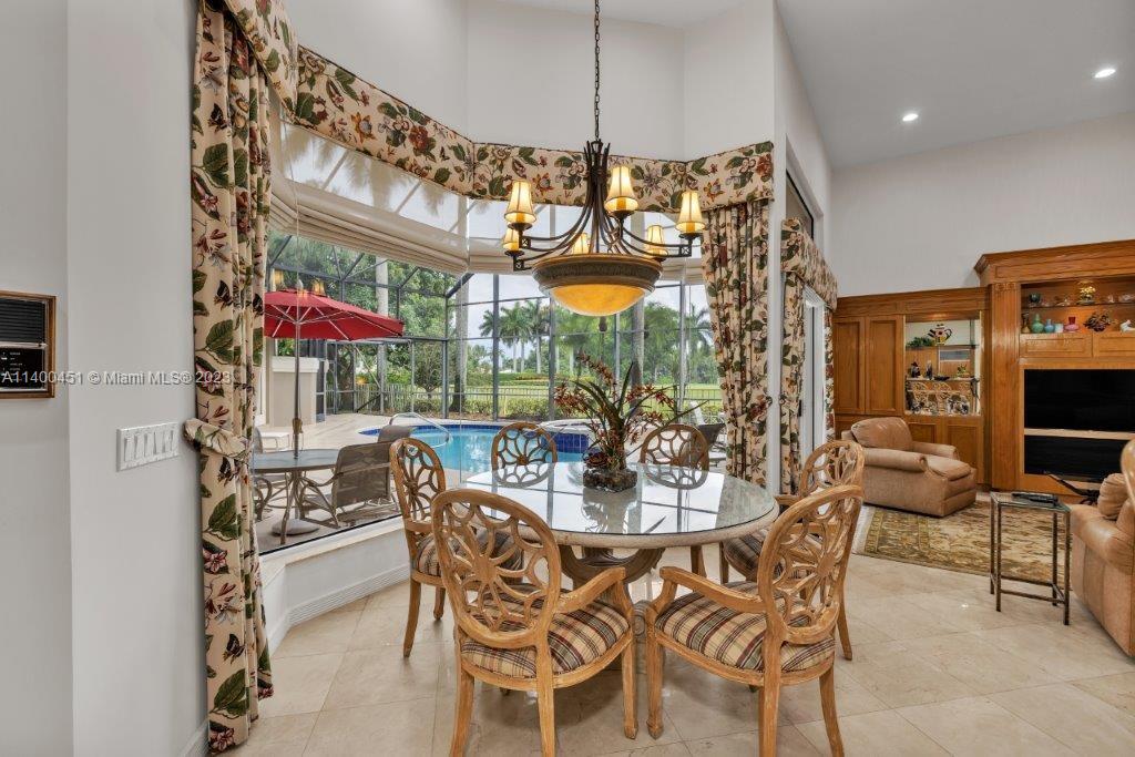 7236 Queenferry Circle Boca Raton, FL 33496 - Photo 24 of 31 a view of a dining room with furniture and chandelier