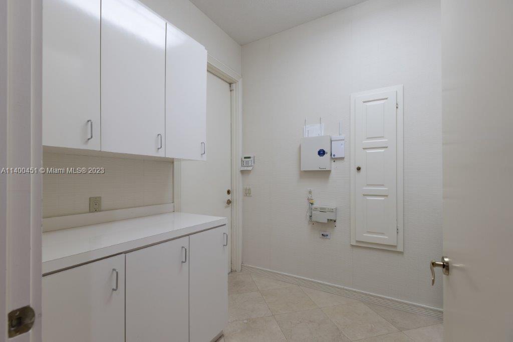 7236 Queenferry Circle Boca Raton, FL 33496 - Photo 26 of 31 a view of cabinets and white kitchen