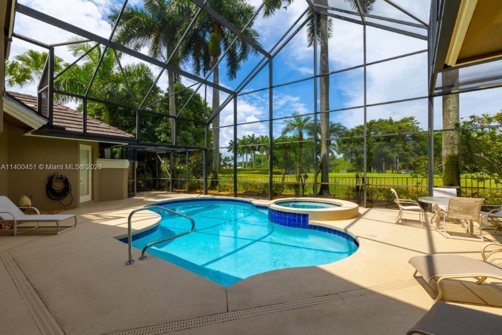 7236 Queenferry Circle Boca Raton, FL 33496 - Photo 27 of 31 a view of a swimming pool with a lounge chairs