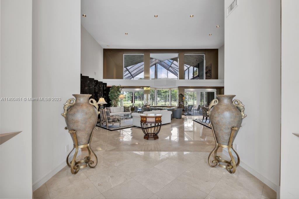 7236 Queenferry Circle Boca Raton, FL 33496 - Photo 4 of 31 a room with lots of white furniture and a window