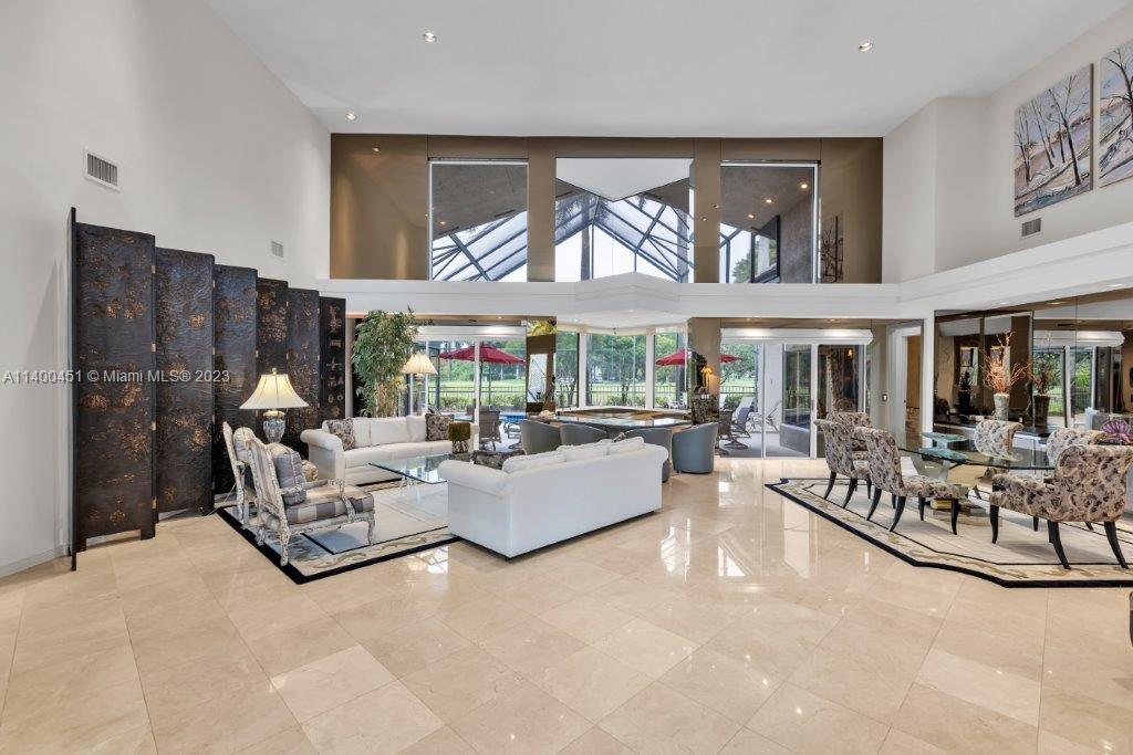 7236 Queenferry Circle Boca Raton, FL 33496 - Photo 6 of 31 a living room with fireplace furniture and a large window