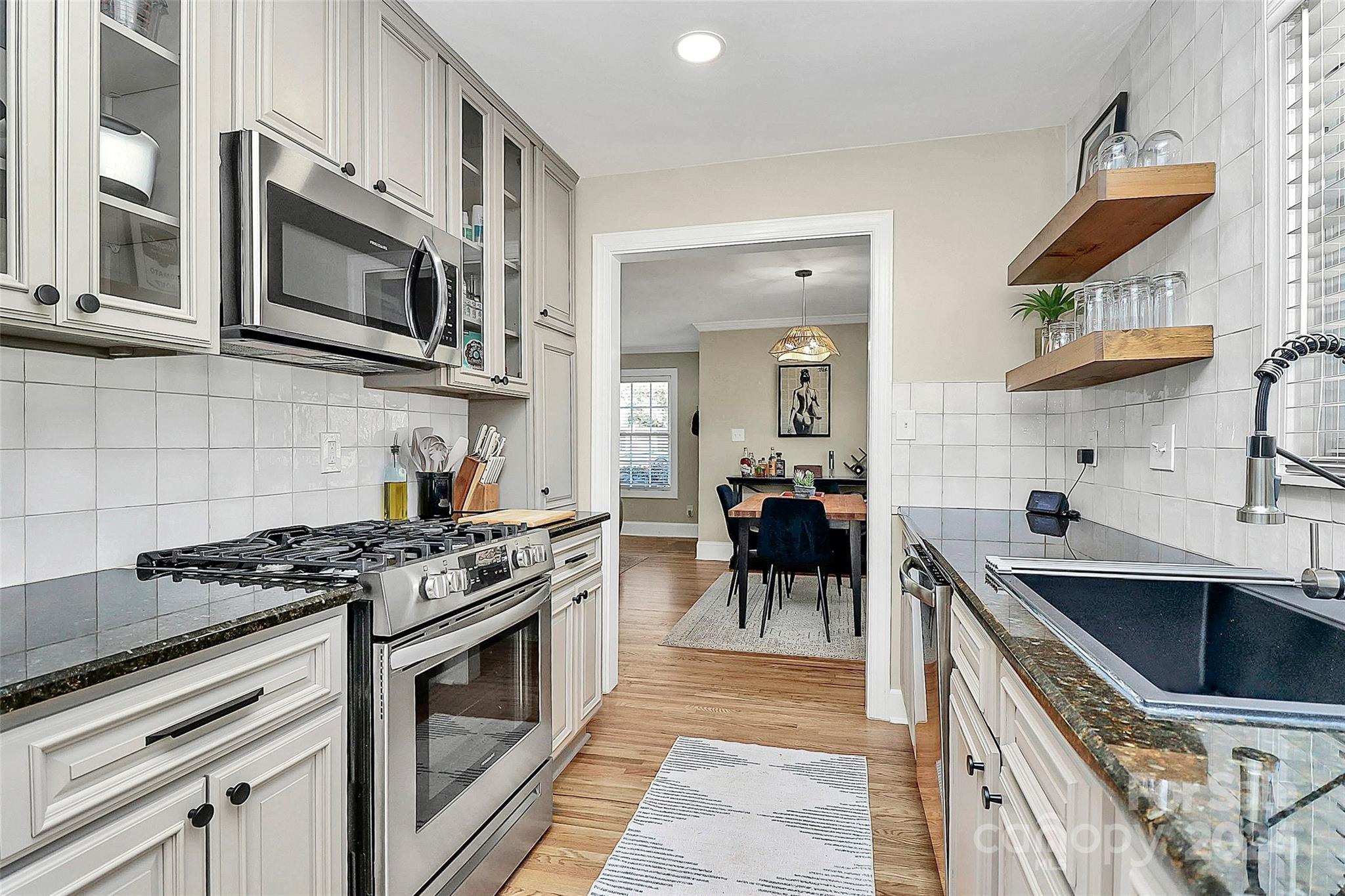 4605 General Pershing Drive Charlotte, NC 28209 - Photo 11 of 35 a kitchen with stainless steel appliances a sink stove and cabinets