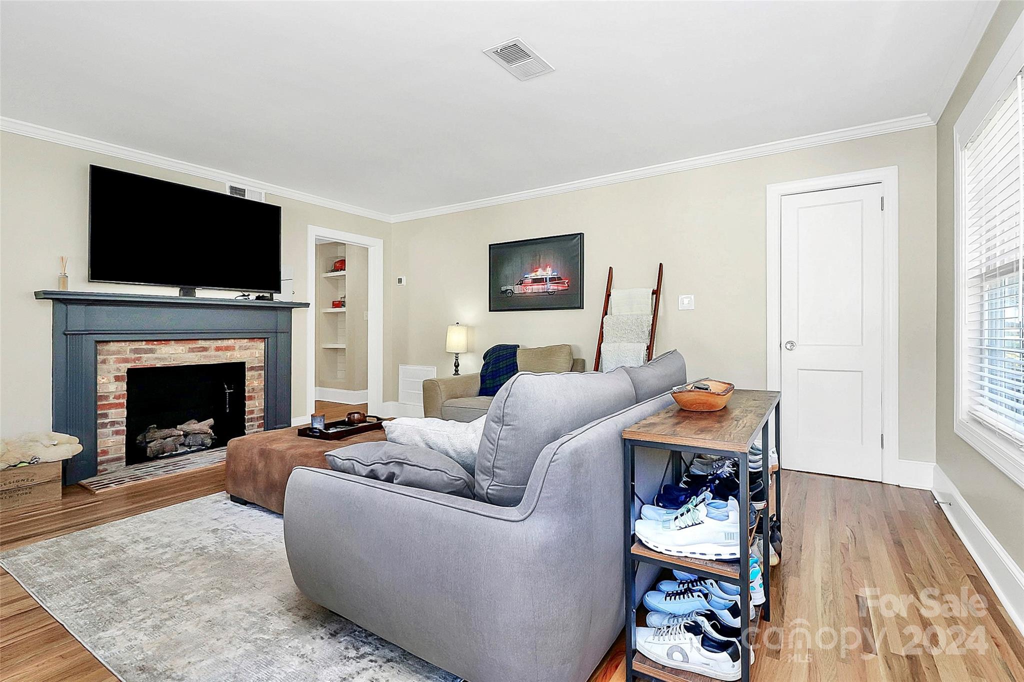 4605 General Pershing Drive Charlotte, NC 28209 - Photo 2 of 35 a living room with furniture a flat screen tv and a fireplace