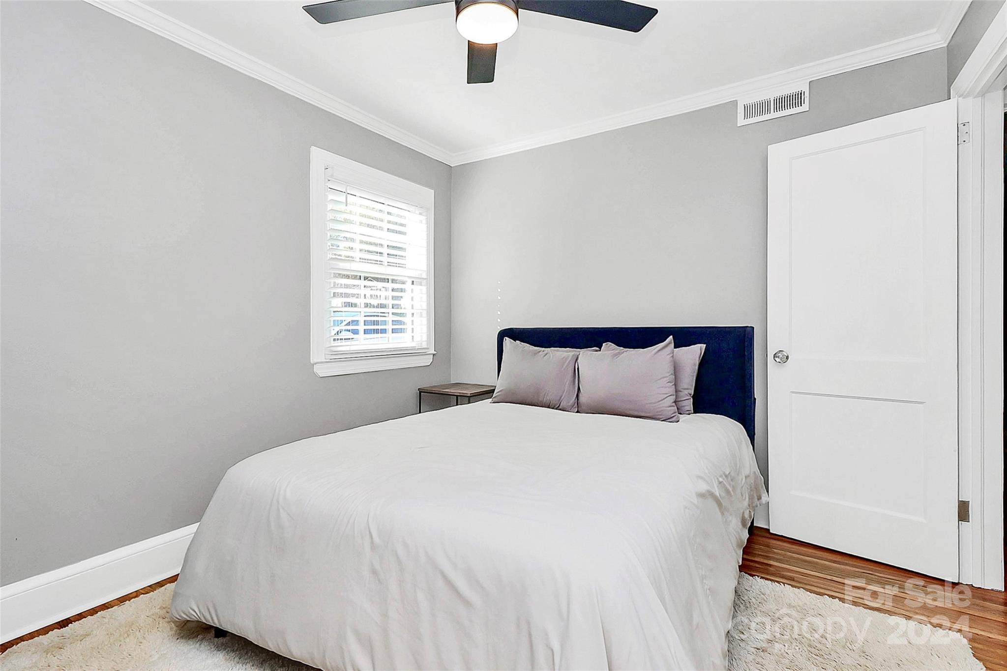 4605 General Pershing Drive Charlotte, NC 28209 - Photo 21 of 35 a large bed sitting in a bedroom next to a window