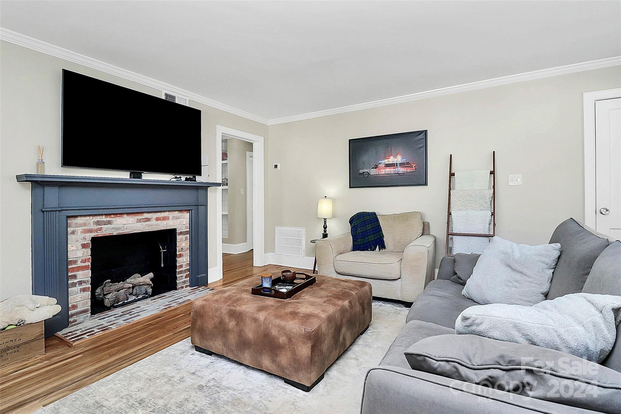 4605 General Pershing Drive Charlotte, NC 28209 - Photo 3 of 35 a living room with furniture a flat screen tv and a fireplace
