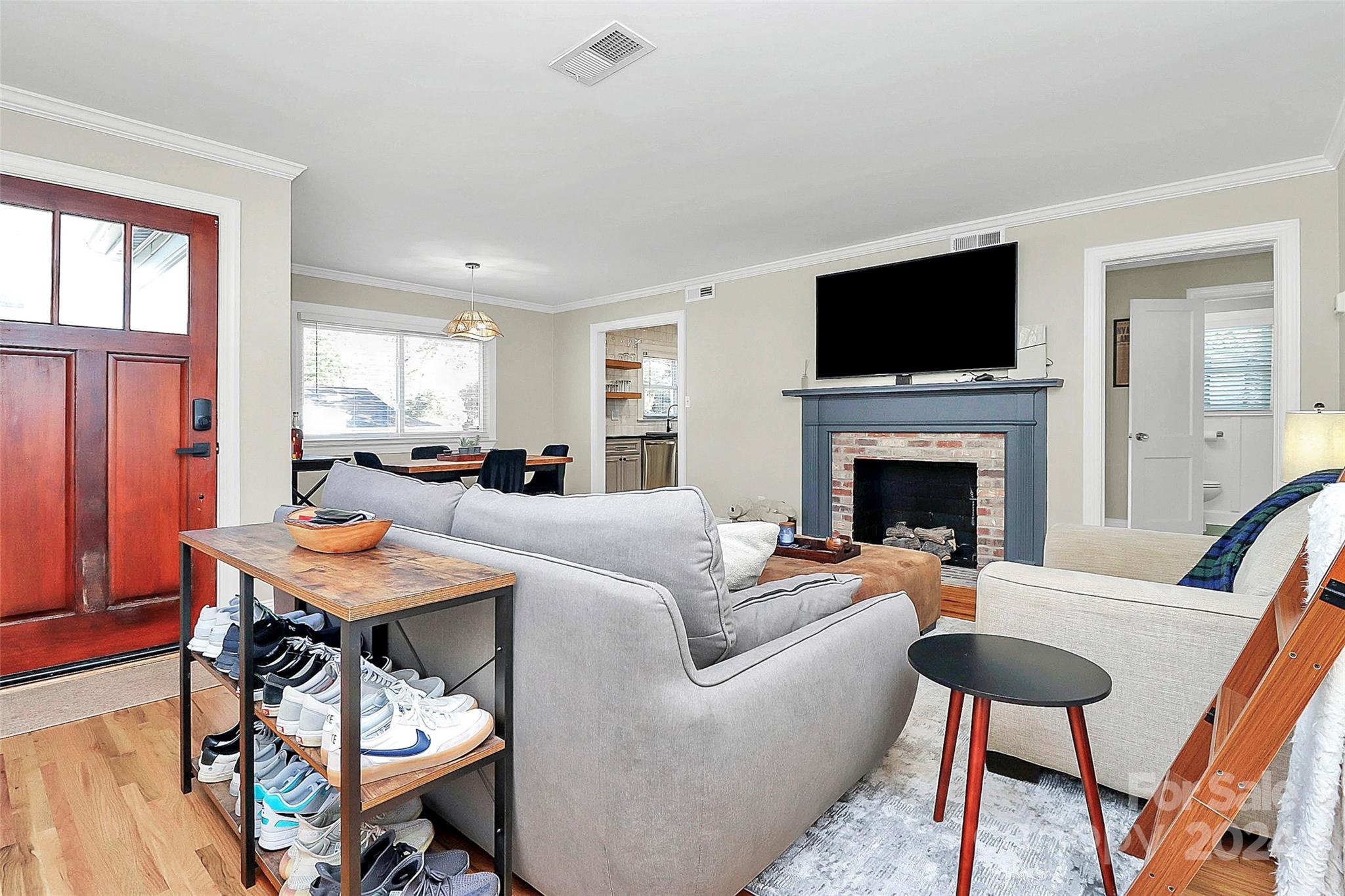 4605 General Pershing Drive Charlotte, NC 28209 - Photo 4 of 35 a living room with furniture a flat screen tv and a fireplace