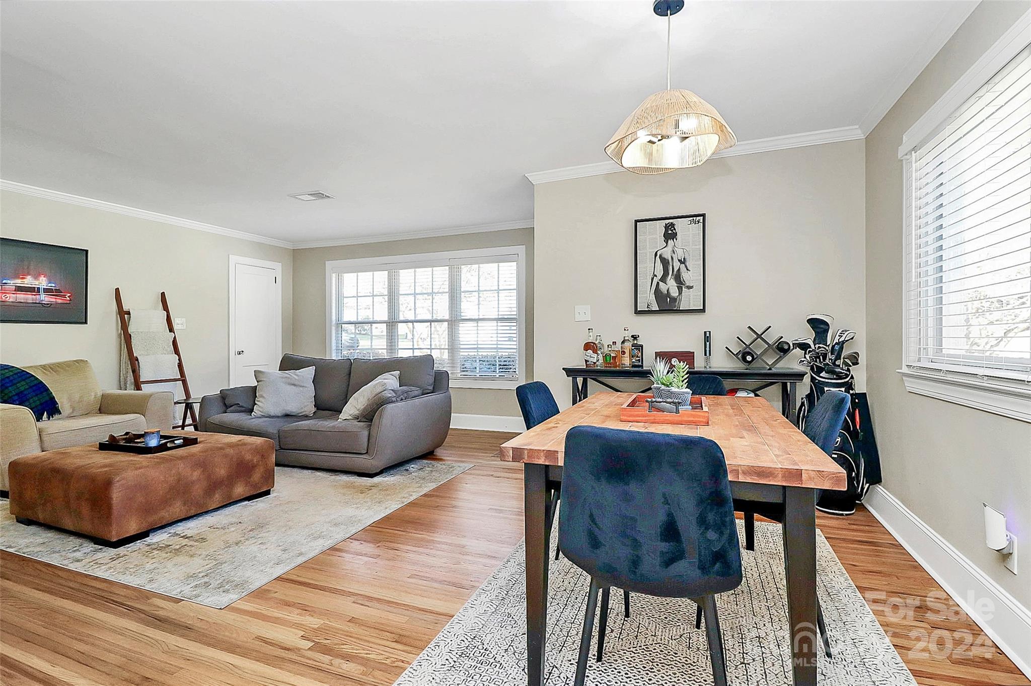 4605 General Pershing Drive Charlotte, NC 28209 - Photo 8 of 35 a living room with furniture a chandelier a rug and a window