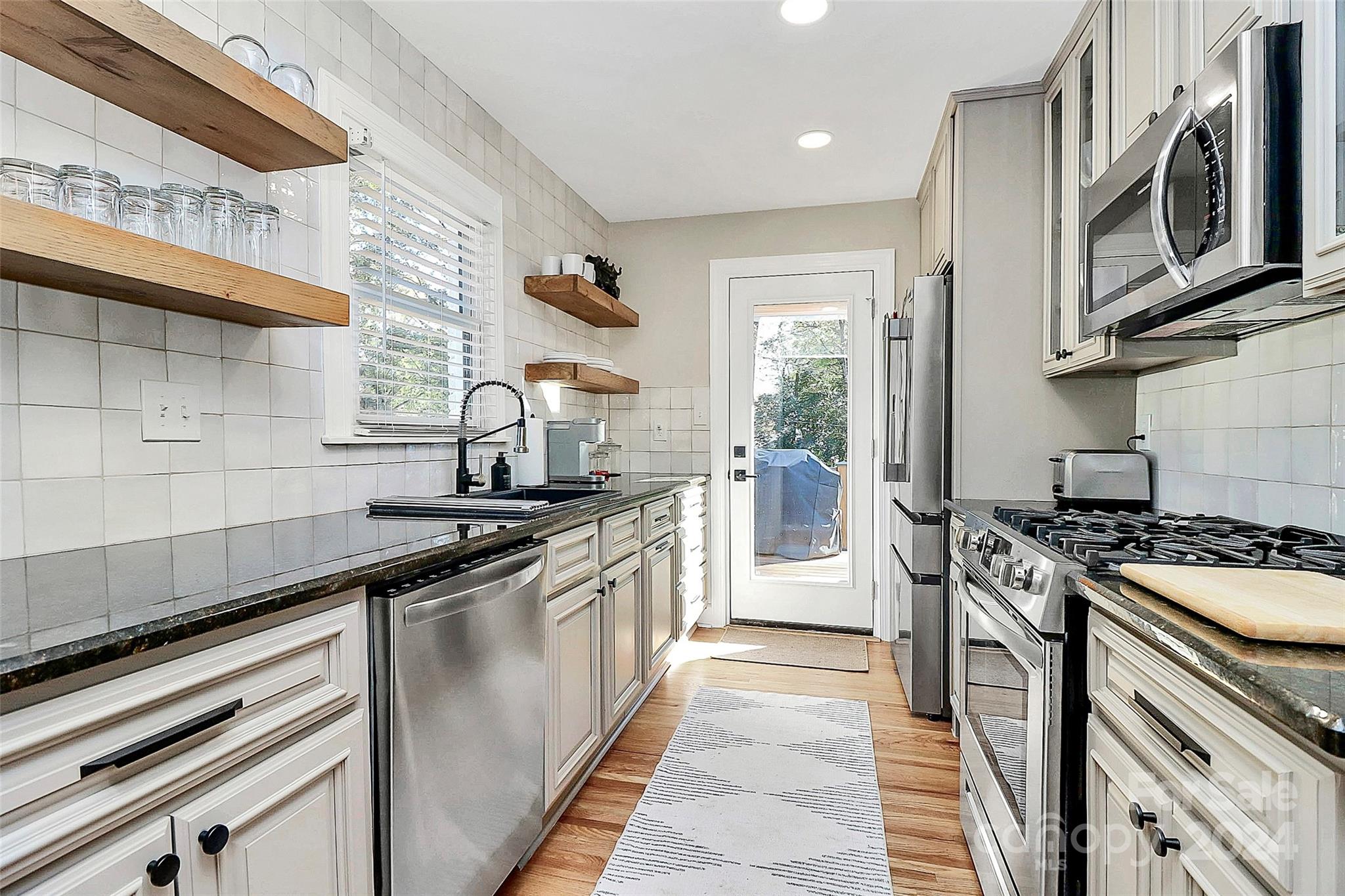 4605 General Pershing Drive Charlotte, NC 28209 - Photo 9 of 35 a kitchen with stainless steel appliances granite countertop a stove and a sink