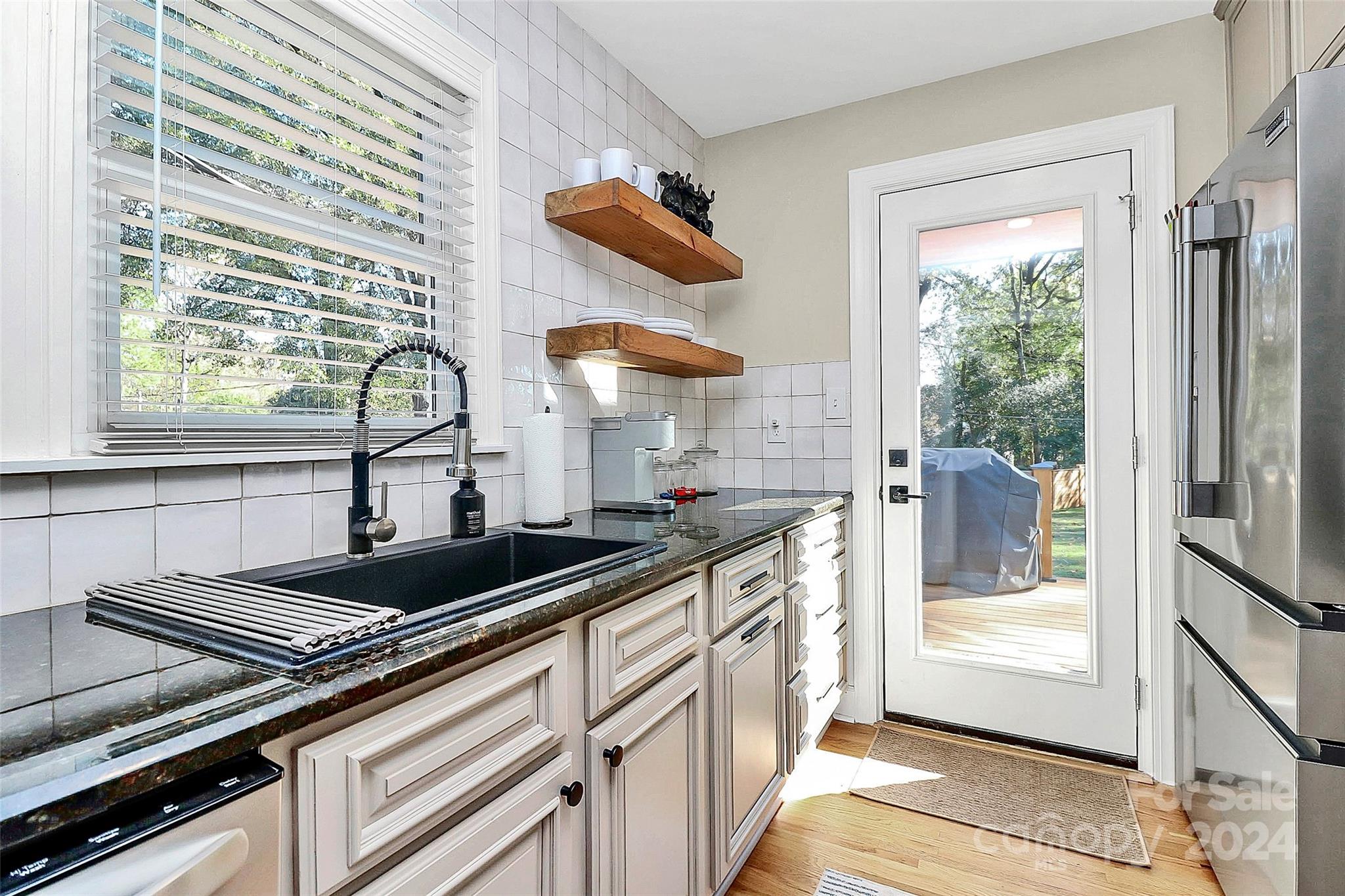 4605 General Pershing Drive Charlotte, NC 28209 - Photo 10 of 35 a kitchen with stainless steel appliances granite countertop a sink and a window