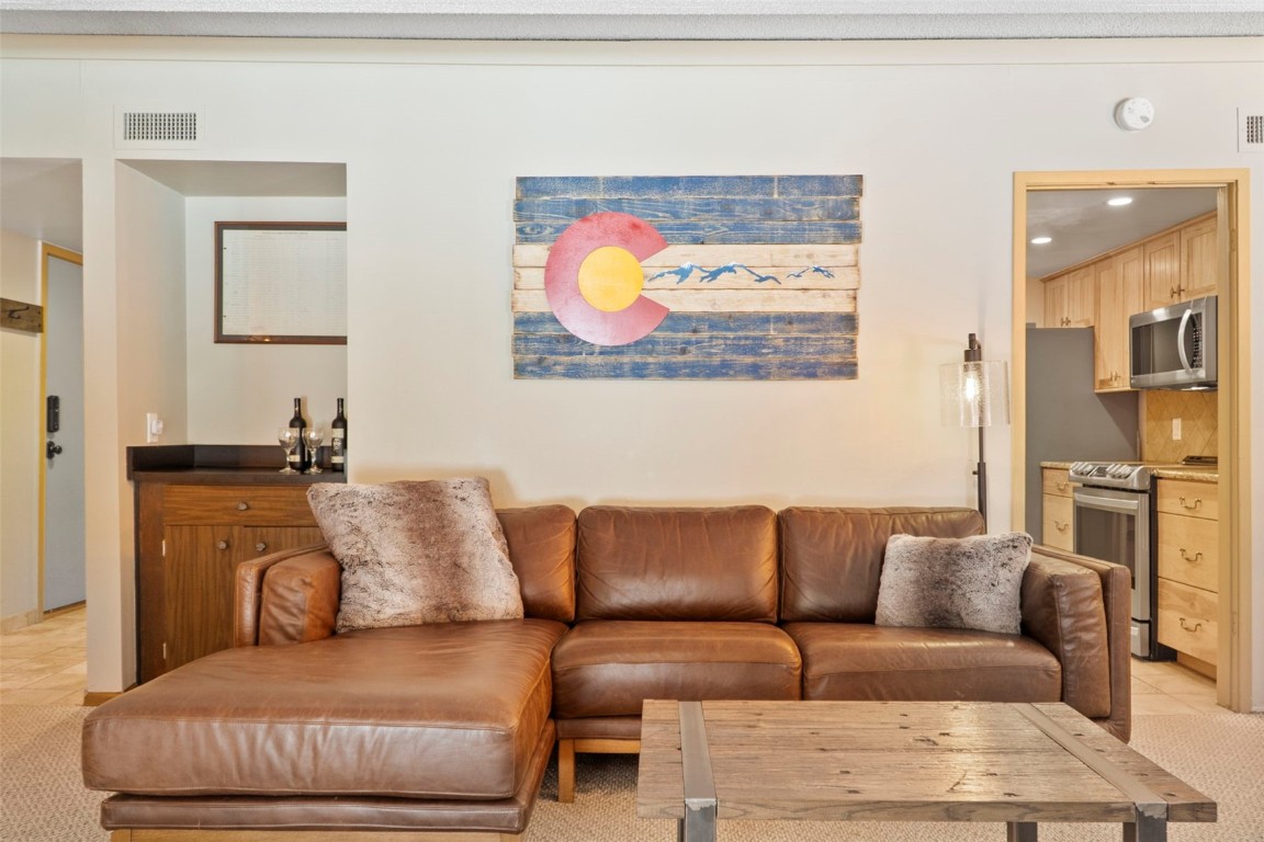a living room with furniture a couch and a painting on the wall