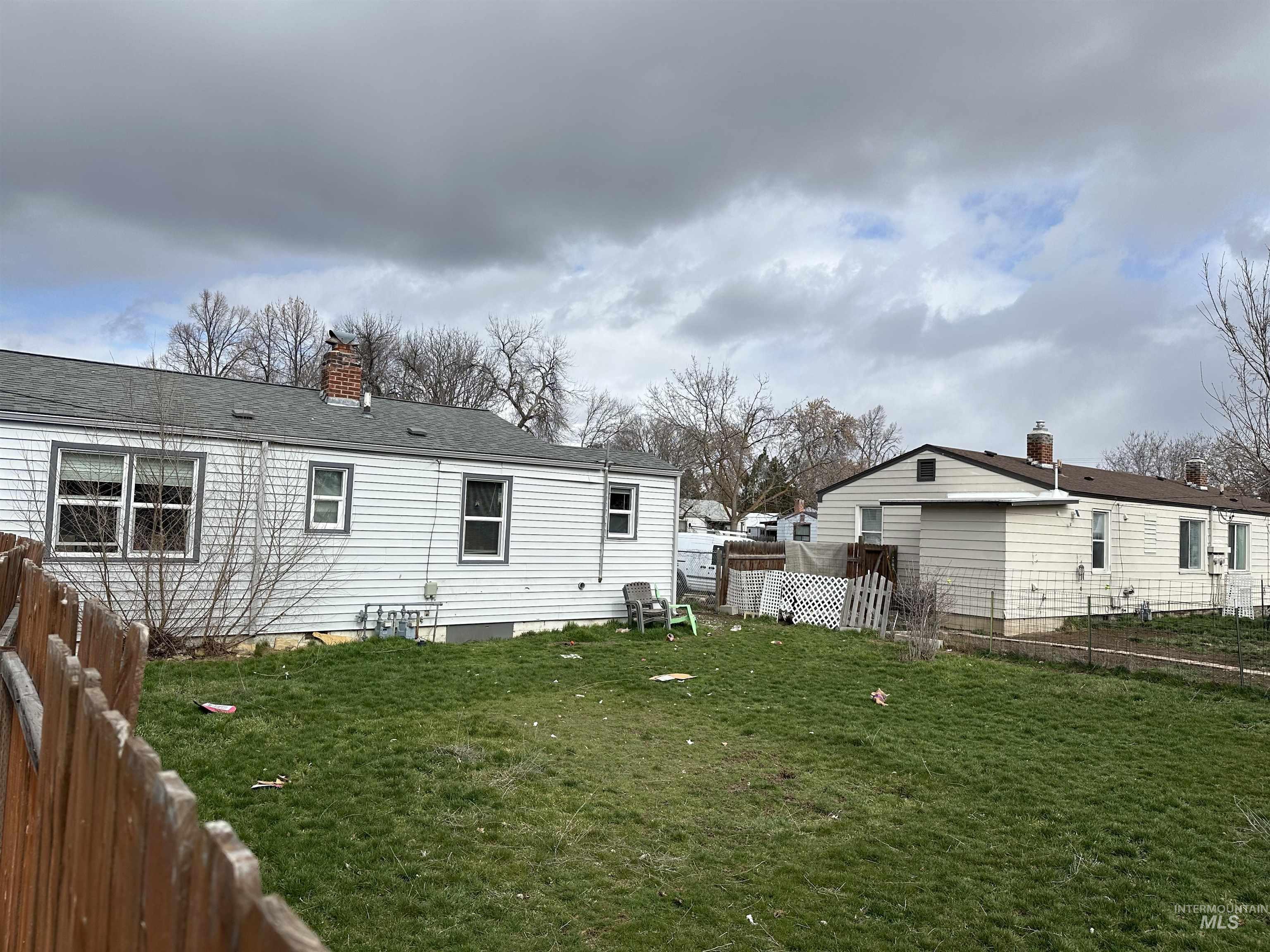 3885 Pershing Drive Boise, ID 83705 - Photo 13 of 14 Back of property featuring a chimney and a shingled roof