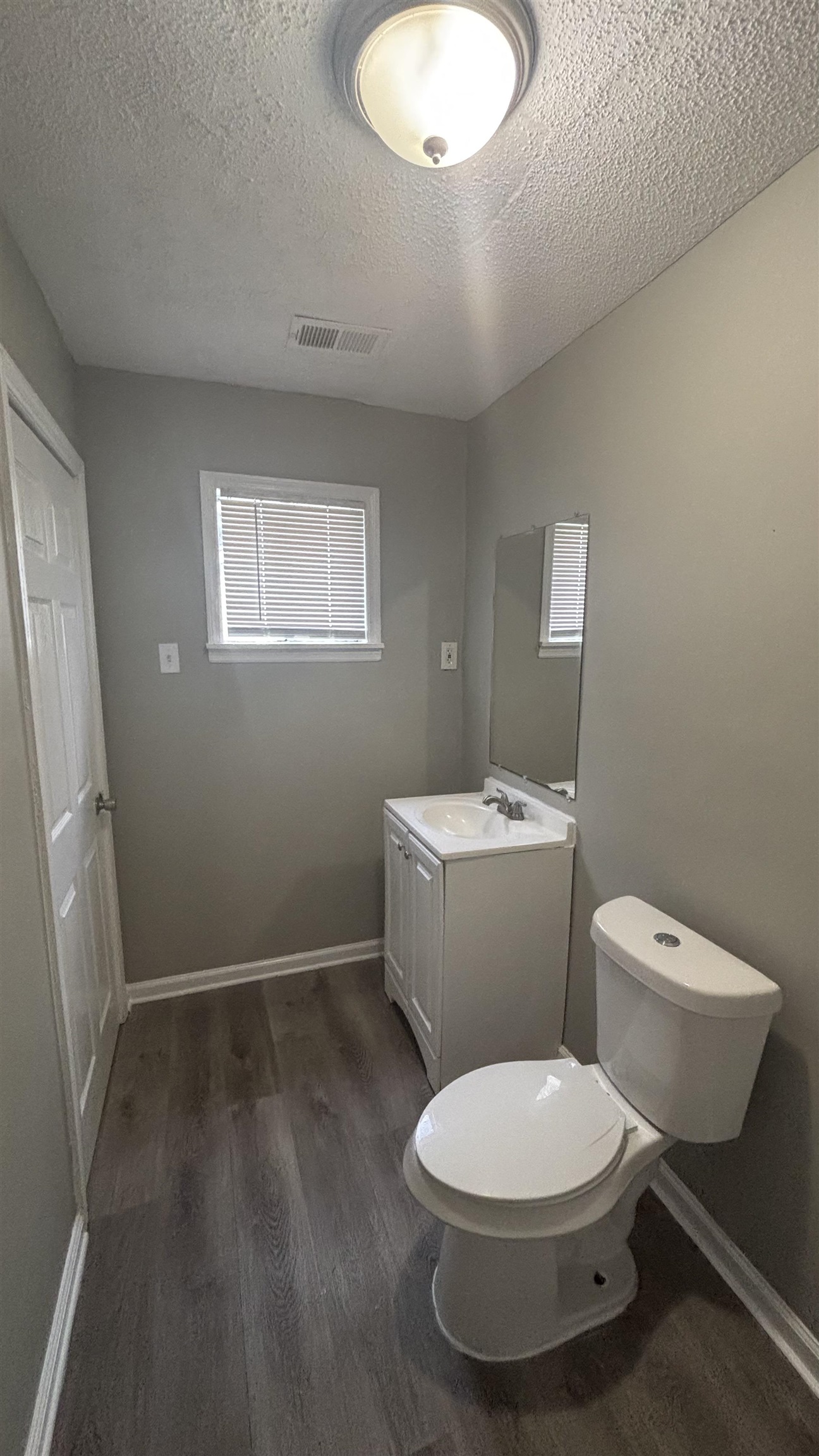 3133 Benjestown Road Memphis, TN 38127 - Photo 14 of 17 a white toilet sitting next to a bathroom sink and vanity