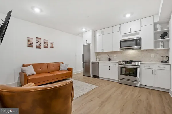 a kitchen with stainless steel appliances granite countertop a stove a refrigerator and a microwave