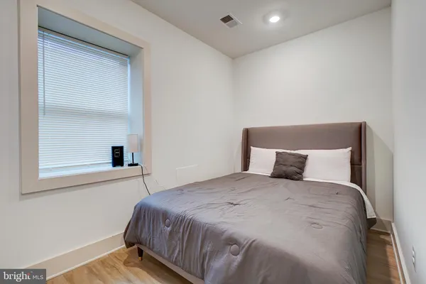 a room with a white wall paint and a white door