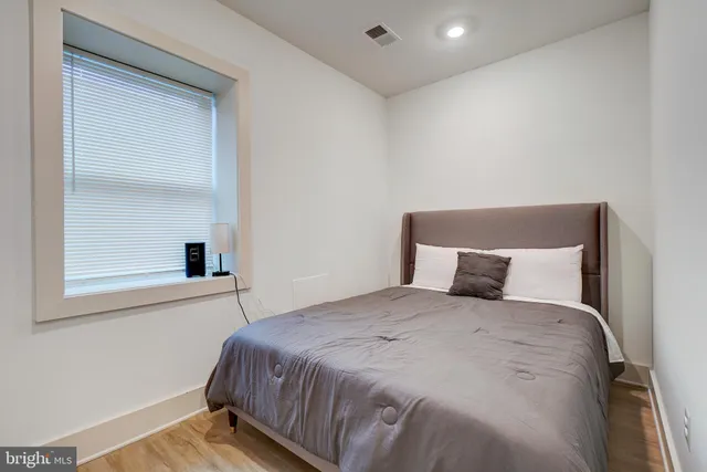 a room with a white wall paint and a white door