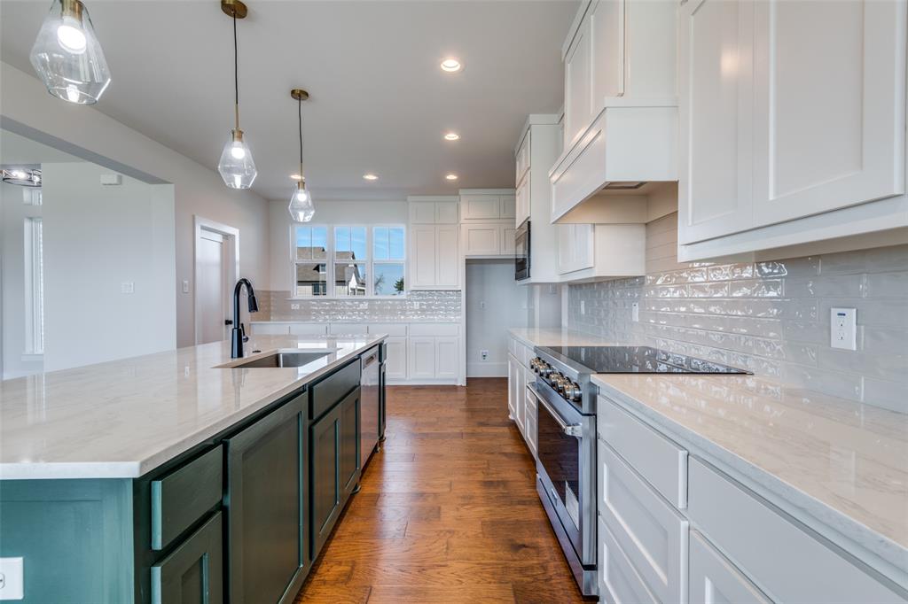 820 Evergreen Way Nevada, TX 75173 - Photo 11 of 37 a kitchen with stainless steel appliances granite countertop a sink a stove and a wooden floors
