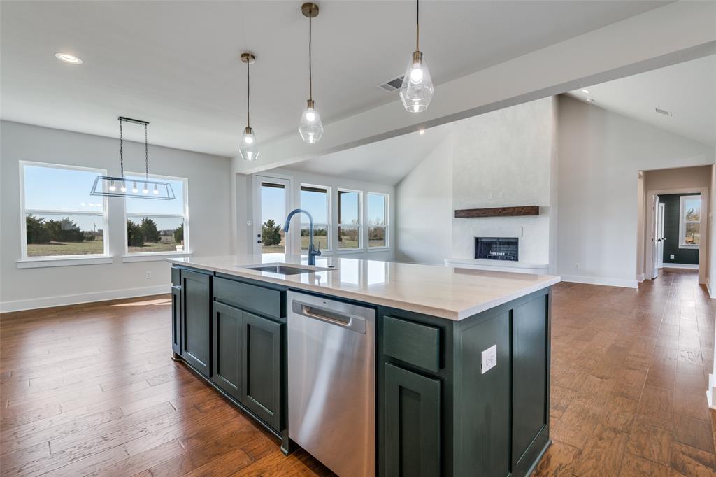 820 Evergreen Way Nevada, TX 75173 - Photo 14 of 37 a kitchen with stainless steel appliances granite countertop a sink a stove and a wooden floors