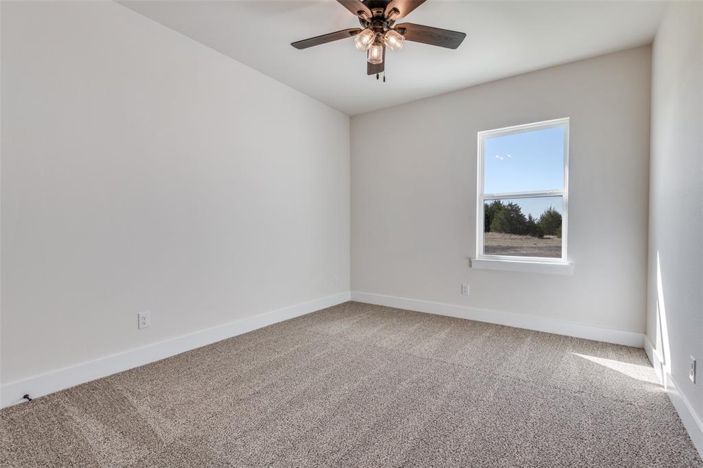 820 Evergreen Way Nevada, TX 75173 - Photo 17 of 37 an empty room with a window and a fan