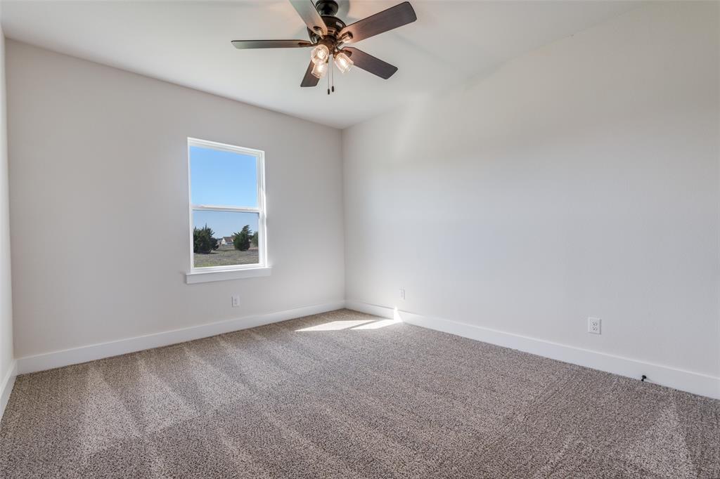 820 Evergreen Way Nevada, TX 75173 - Photo 18 of 37 an empty room with windows and fan