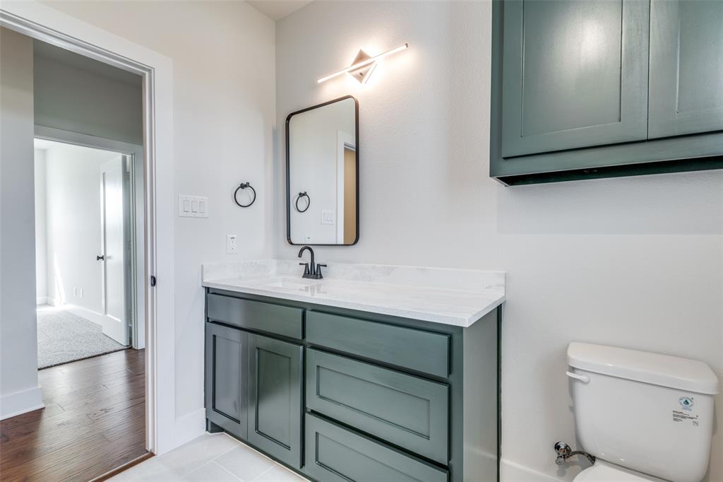 820 Evergreen Way Nevada, TX 75173 - Photo 20 of 37 a bathroom with a sink a toilet and mirror