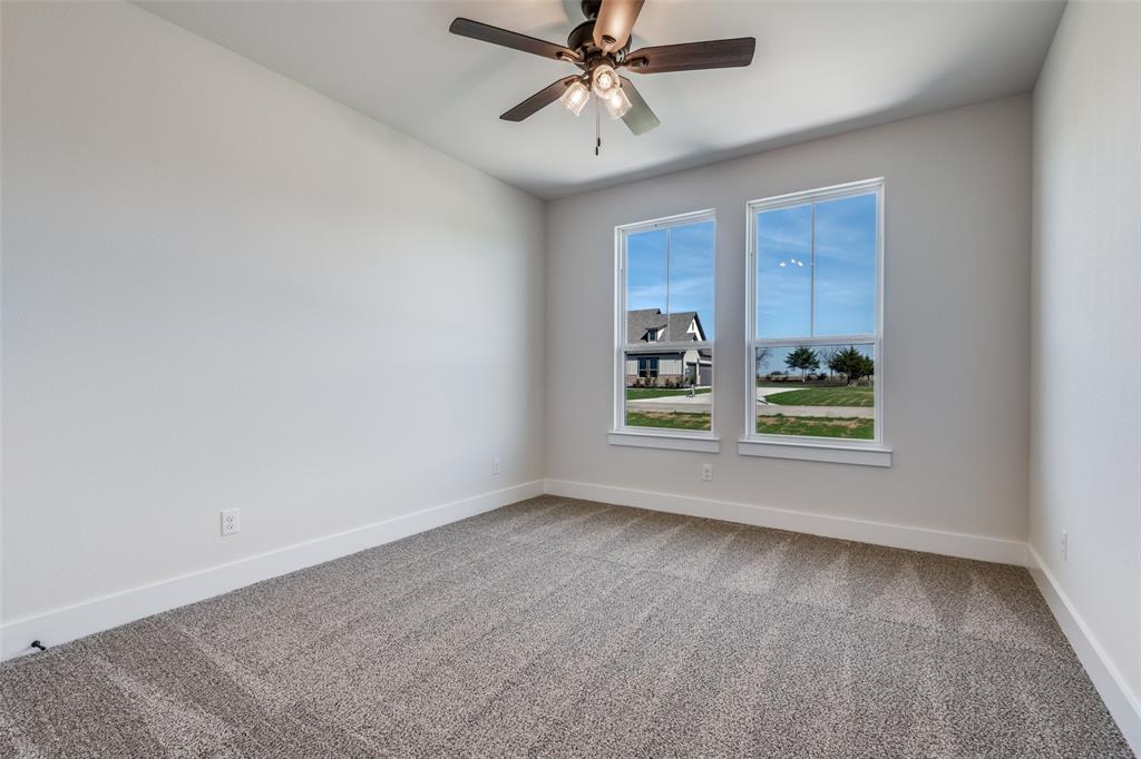 820 Evergreen Way Nevada, TX 75173 - Photo 22 of 37 an empty room with windows and ceiling fan