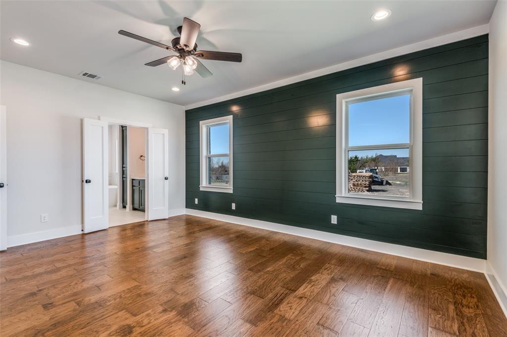 820 Evergreen Way Nevada, TX 75173 - Photo 29 of 37 a view of an empty room with wooden floor and a ceiling fan