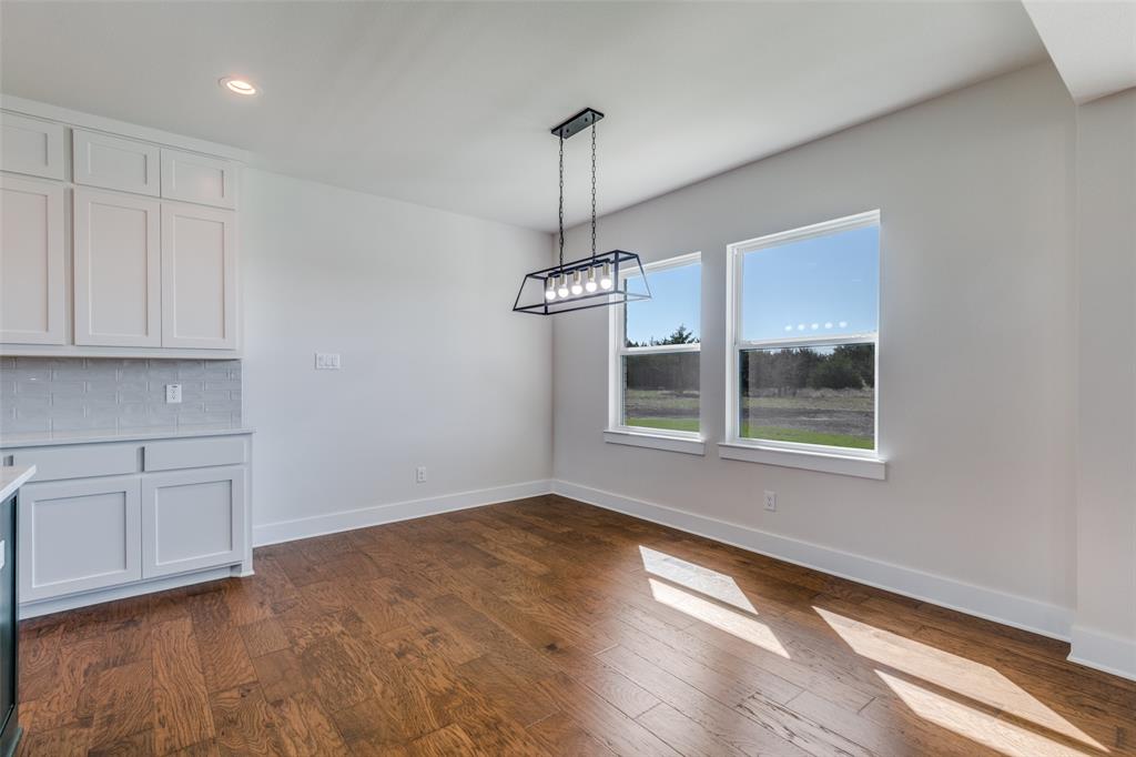 820 Evergreen Way Nevada, TX 75173 - Photo 9 of 37 a view of an empty room with window and wooden floor