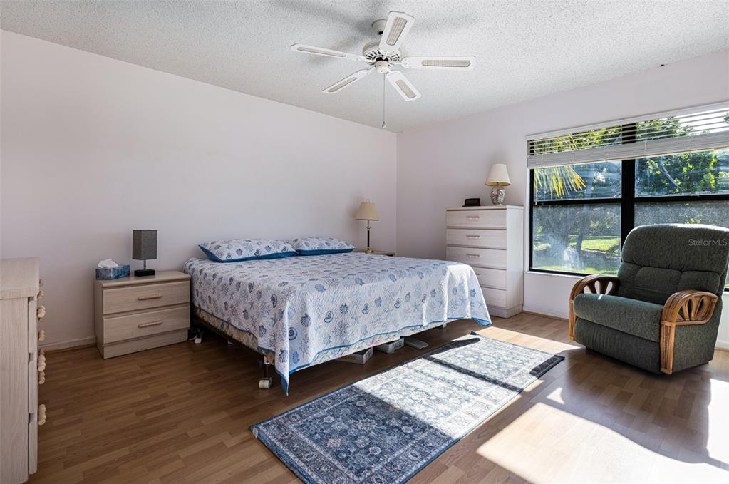 3041 Matecumbe Key Road, Unit 4 Punta Gorda, FL 33955 - Photo 11 of 33 a bedroom with a bed a couch and a window