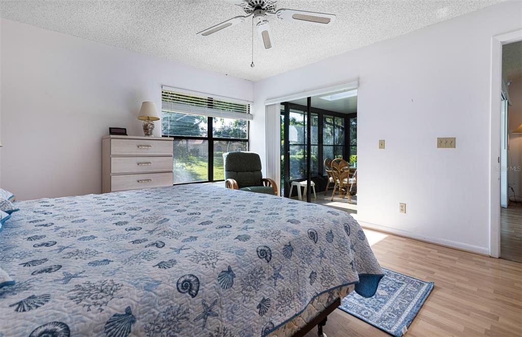 3041 Matecumbe Key Road, Unit 4 Punta Gorda, FL 33955 - Photo 12 of 33 a bedroom with a bed and wooden floor