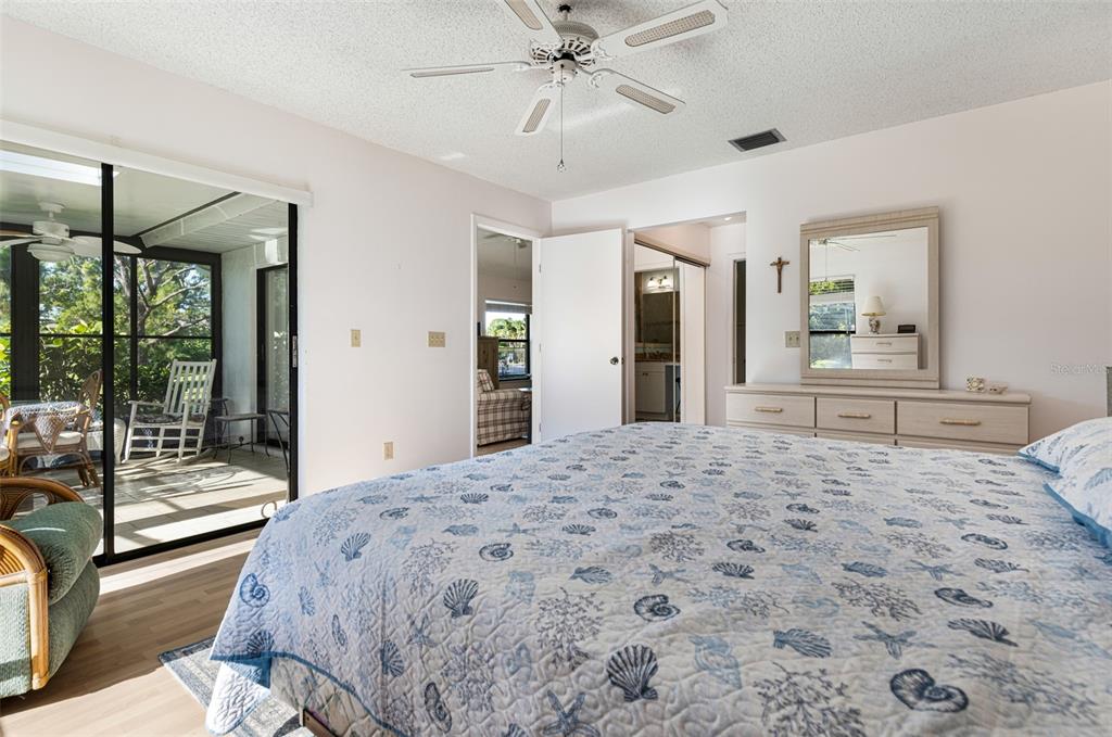 3041 Matecumbe Key Road, Unit 4 Punta Gorda, FL 33955 - Photo 13 of 33 a bedroom with a large bed and a chandelier