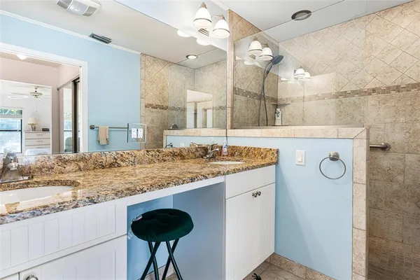 a bathroom with a granite countertop sink a large mirror and vanity