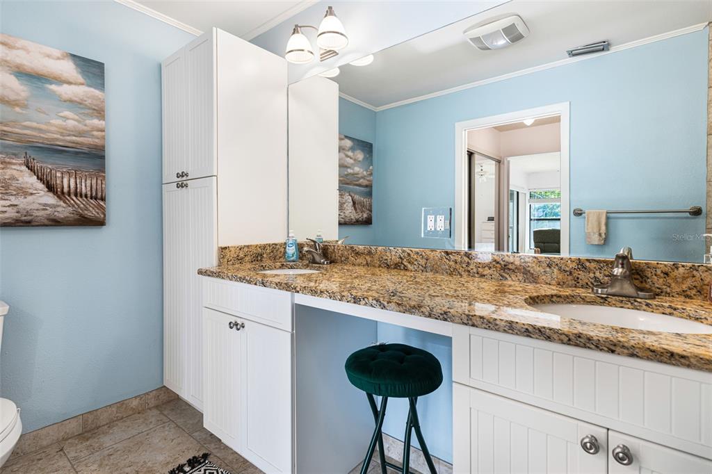3041 Matecumbe Key Road, Unit 4 Punta Gorda, FL 33955 - Photo 17 of 33 a bathroom with a granite countertop sink and a mirror