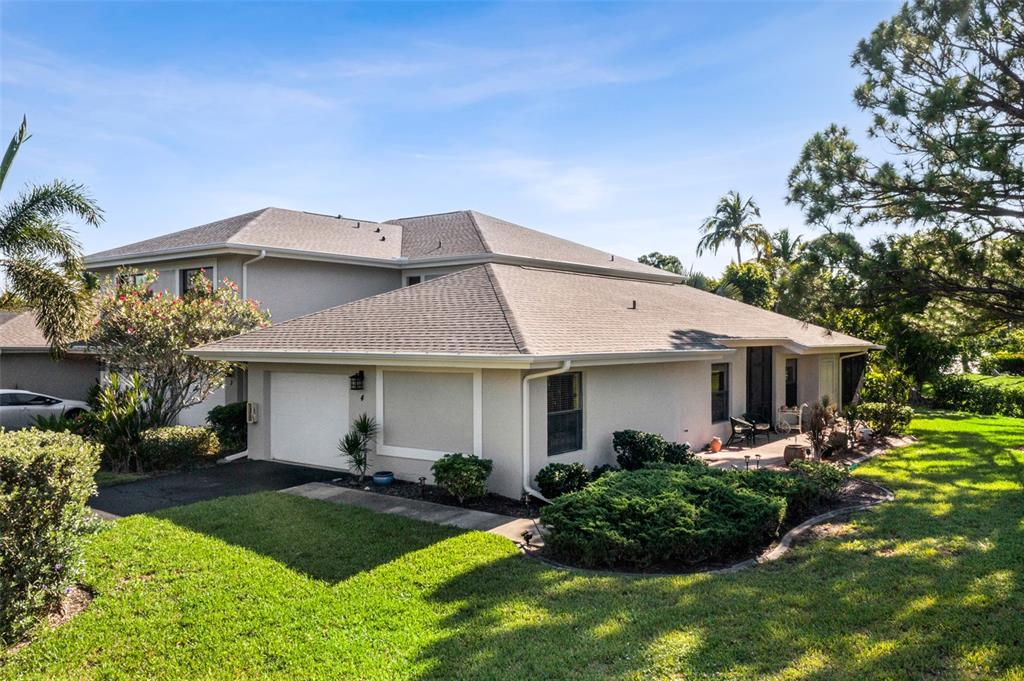 3041 Matecumbe Key Road, Unit 4 Punta Gorda, FL 33955 - Photo 20 of 33 a front view of a house with a garden