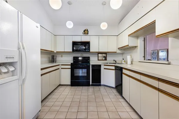 a kitchen with stainless steel appliances granite countertop a refrigerator sink and cabinets