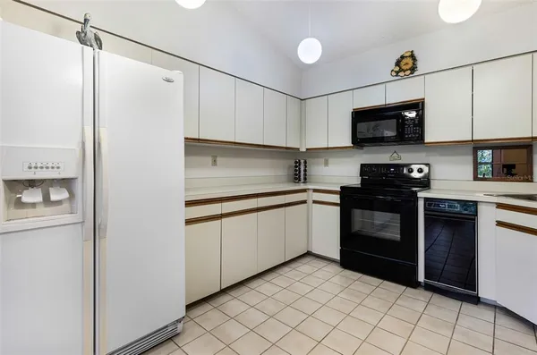 a kitchen with a sink and a refrigerator