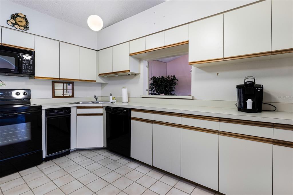 3041 Matecumbe Key Road, Unit 4 Punta Gorda, FL 33955 - Photo 23 of 33 a kitchen with stainless steel appliances granite countertop a sink and a stove